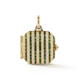 A structured heirloom locket designed with intention and quiet but bold detail, drawing structure inspiration from antique fob watches.
Alternating rows of green tourmaline baguettes and diamonds form a striped pattern that feels both graphic and timeless. A balance of color that reflects our love of thoughtful contrast.
The reverse reveals a niello-inspired enamel line, a continued nod to antique jewelry and the hidden design elements that make a piece feel personal. It opens to hold photos or small keepsa