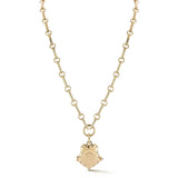 A structured, heirloom-worthy shield-shaped locket with diamond-set stars tracing the surface. Adding light, symbolism, and a sense of strength to its sculptural form.
At the center, a circular field is designed for personalization. A space for initials, numbers, or a mark that makes the piece distinctly your own. Thoughtful details continue throughout, including a cabochon blue sapphire opening inspired by traditional watch fobs. The locket is designed to hold photos or small keepsakes, creating space for